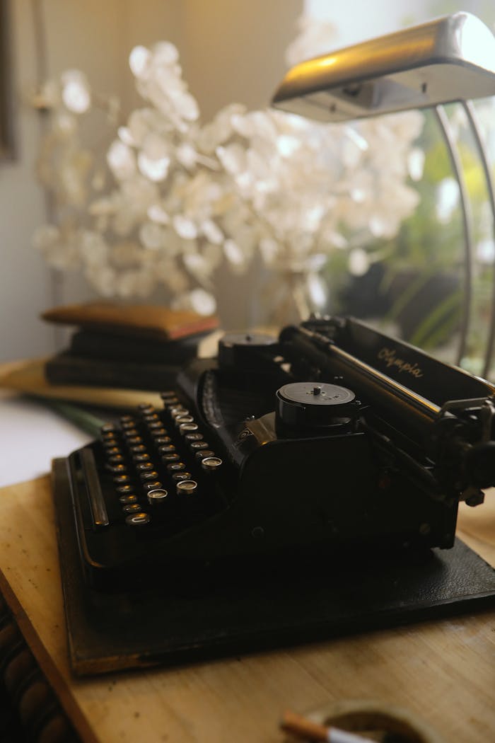 Close-up of a vintage typewriter in a cozy indoor setting with warm lighting.
